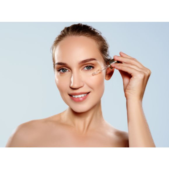 Kobieta nakładająca pipetką serum na twarz - tytułowa