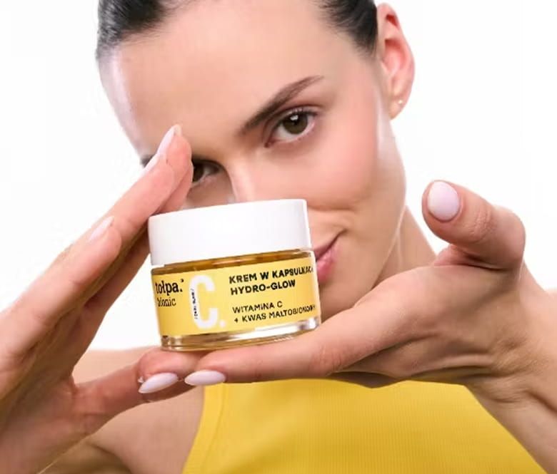  tołpa® bionic dual glow. krem w kapsułkach hydro-glow - kobieta trzymająca krem w dłoniach - zdjęcie